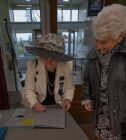 Selina Prescott signing the Commemorative Album