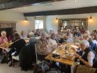 A room full of members enjoying lunch.